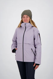Frontansicht einer Frau mit olivgrüner Beanie-Mütze in einer fliederfarbenen Belowzero Damen Outdoorjacke mit hochgeschlossenem Kragen und Seitentaschen.